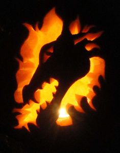 a carved pumpkin with the shape of a dragon on it