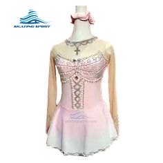 a pink and white dress with beading on it