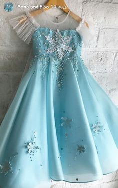 a blue dress with snowflakes on it