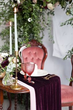 the table is set with candles, flowers and other items for an elegant dinner party