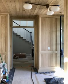 the inside of a house being remodeled with wood paneling