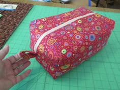 someone is making a bag out of fabric