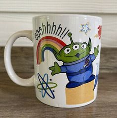 a coffee mug with an alien on it