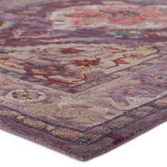 an area rug with various colors and designs on it, including pinks, purples, yellows and green