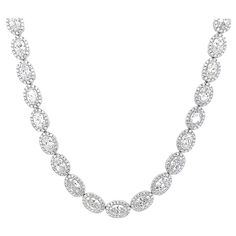 Stunning oval diamond tennis necklace east-west. High jewelry by Alexander Beverly Hills. 22.18 carats total diamond weight. 45 oval diamonds, 18.55 carats total. Approximately F/G color and SI1 clarity. Complimented with 730 round brilliant diamonds, 3.63 carats. Approximately E/F color and VS clarity. Four prong set in 18k white gold, 30.58 grams, 16 inches. Accommodated with an up-to-date digital appraisal by a GIA G.G. once purchased, upon request. Please contact us with any questions. Item Number NS1760 Diamond Tennis Necklace, Tennis Necklace, East West, Oval Diamond, High Jewelry, Halo Diamond, Round Brilliant, Beverly Hills, Prong Setting