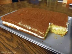 a cake that has been cut in half on a pan with one slice missing from it