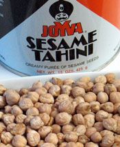 some peanuts are sitting next to a can of sesame tahn