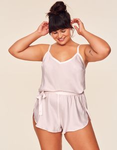 Our silky-smooth Kami Romper is all about understated elegance. Made from ultra-luxe satin with a matching sash tie to highlight your waist, this one-piece makes for an easy yet practical lingerie piece you can wear all night long. (Available in plus-sizes XS–4X.) Elegant Sleepwear With Tie Waist, Chic Silk Sleepwear With Satin Finish, Chic Satin Sleepwear, Chic Satin Finish Sleepwear, Feminine Satin Sleepwear For Loungewear, Feminine Satin Finish Sleepwear For Loungewear, Solid Satin Camisole For Loungewear, Chic Satin Sleepwear For Summer, Chic Sleepwear With Built-in Bra