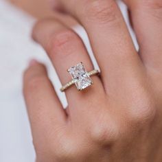 a woman's hand with a diamond ring on it