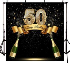 a 50th birthday backdrop with two champagne bottles