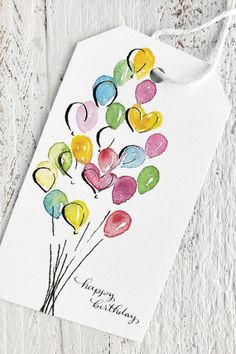 a birthday card with watercolor balloons on it