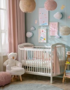 a baby's room with blue walls and pink curtains