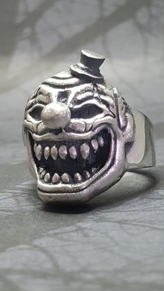 "*MAY SLIGHTLY DIFFER FROM PICTURES AS EACH ONE IS HANDMADE* .925 Solid Sterling Silver Handmade Clown Ring AMERICAN MADE Each ring is handmade and can be made any size The Weight will vary depending on size (A Size 11 Weighs 22 Grams) We have sold many rings around the world and each is custom made through a Lost Wax casting process using a hand cut master pattern Each ring is hand crafted and is stamped on the inside \"STER\" This ring will come with a black ring box and will be wrapped in an Clown Ring, Black Ring Box, Sugar Skull Ring, Many Rings, Fairy Tattoo Designs, Fairy Tattoo, Diamond Eyes, Black Ring, Wax Casting