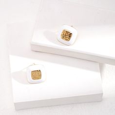 Introducing our Sterling Silver Square Drop Glaze Stud Earrings, where modern design meets classic elegance. Contemporary Square Design: These earrings feature sleek and minimalist square-shaped studs, adding a touch of modern sophistication to any outfit. The clean lines and geometric shape make them perfect for both casual and formal occasions.Glaze Finish: Each stud is adorned with a glossy glaze finish, adding a subtle shine and depth to the design. The glaze creates a smooth and polished surface, enhancing the visual appeal of the earrings and catching the light beautifully.Sterling Silver Construction: Crafted from genuine sterling silver, these earrings offer durability, shine, and hypoallergenic properties for sensitive ears. Stud Earrings Style: The stud earrings style provides a Modern Gold Enamel Earrings, Modern Gold Earrings With Enamel, Modern Enamel Earrings For Formal Occasions, Modern Formal Enamel Earrings, Elegant Rectangular Enamel Jewelry, Luxury White Enamel Earrings, Elegant White Rectangular Jewelry, Classic Square Earrings For Gift, Classic Square Earrings As Gift