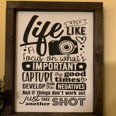 a framed poster with the words life is like a camera and it's important to capture