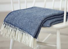 a blue and white blanket sitting on top of a chair