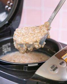 a spoon full of oatmeal is being lifted from an air fryer