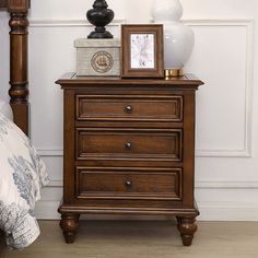 a night stand with two drawers and a clock on top