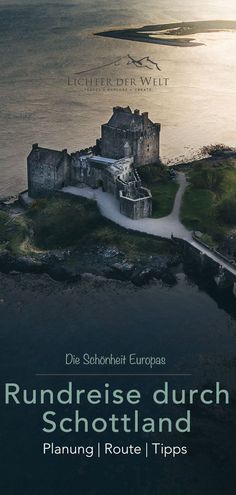 an aerial view of a castle with water in the background