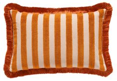 an orange and white striped pillow with fringe trim