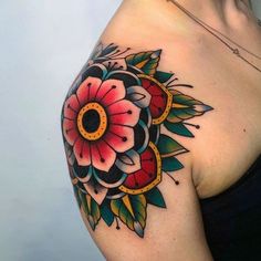 a woman's shoulder with a flower tattoo on her left arm and the upper half of her body