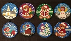 cross stitch christmas ornament designs on a black background with brown fabric behind them