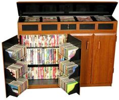 an entertainment center with many dvd's and video games on it, including the doors open