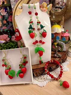 Strawberry Necklace, Earring and Bracelet set, Fruit Jewelry, Summer Jewelry, Jewelry Set, Beaded Jewelry, Colorful 🍓Strawberry charm earring, bracelet  and necklace set 🛍️ 🍓Strawberry Fairycore Dangle Earrings and beaded dangle chain necklace with extender 🍃 🍓Summer is almost here! Handmade strawberry charmed earrings and necklace with #czechbeads and cute green leaf charms 🍃 🌷Handmade with love  ☀️Perfect for Spring, Summer or any occassion!! The strawberry charms are vibrant in color and really pop ♡ Shipping📦 Ships the next day with USPS. Tracking info is available on Etsy. USA orders usually arrives in 2-3 days after being shipped  ♡ Packaging  All jewelry is set on a homemade display card with cute stickers and hand written note Handmade Fairycore Jewelry For Parties, Fairycore Multicolor Jewelry For Gifts, Multicolor Fairycore Jewelry For Gifts, Handmade Adjustable Fairycore Jewelry, Handmade Fairycore Jewelry Gift, Handmade Multicolor Fairycore Jewelry, Strawberry Jewelry Aesthetic, Adjustable Beaded Fairycore Jewelry, Fairycore Beaded Jewelry Gift