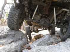 an off - road vehicle is parked on some rocks