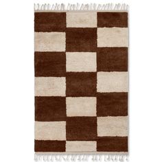 a brown and white rug with squares on it