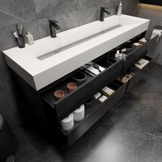 a bathroom sink sitting under a mirror next to a wall mounted faucet with soaps and toothbrushes