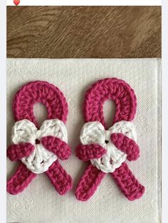 two crocheted scissors sitting on top of a napkin