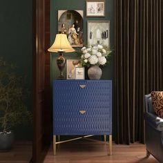 a living room with green walls and blue furniture