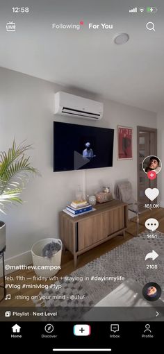 a living room filled with furniture and a flat screen tv on top of a wall