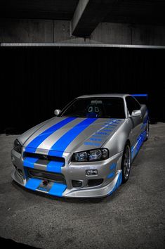 a silver and blue car parked in a garage