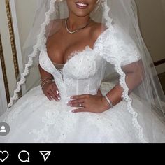 a woman in a wedding dress posing for the camera with her veil over her head