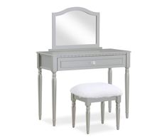 a white dressing table with a mirror and stool