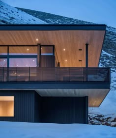 a modern house on top of a snowy hill