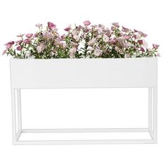 a white planter with pink flowers in it