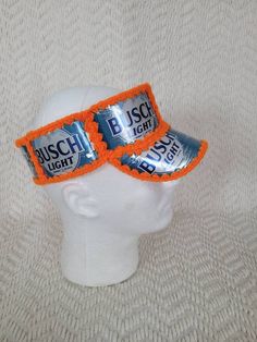 an orange headband with two cans of busch light on it