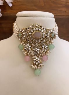 Adorn yourself in timeless elegance with this exquisite mint green and pink Kundan  necklace set, perfect for weddings and special occasions. Crafted with meticulous attention to detail, the set features delicate pink and green hues reminiscent of Pakistani and Punjabi traditions, with a touch of Bollywood glamour. Complete with matching earrings and a stunning maangtika, this Indian Kundan ensemble effortlessly captures the essence of sophistication and grace. Measurements- Necklace Length-14" Punjabi Earrings, Choker Necklace Wedding, Mint Green And Pink, Kundan Choker Necklace, Bollywood Glamour, Polki Choker, Jewelry Pakistani, Kundan Necklace Set, Kundan Choker