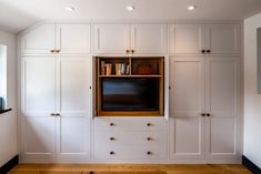 an entertainment center with built - in bookshelves and cabinets