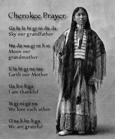 an native american woman standing in front of a poem