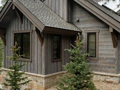 a small wooden house sitting in the middle of a forest