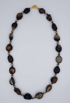 These Beads are Antique Ancient agate Stone Beads it's very old beads the Necklace has been made recently and the lock is Gold Plated its also new the Beads Are real Old more then 1000 years old Its called Sulimani Agate Banded Beads Stone Agate Origin Yeman Length 54 Brown Necklaces With Polished Oval Beads, Artisan Brown Beaded Necklace With Oval Beads, Artisan Brown Beaded Necklaces With Oval Beads, Vintage Agate Beaded Necklace With Large Beads, Vintage Agate Beaded Necklaces With Large Beads, Earthy Agate Beaded Necklaces With Round Beads, Artisan Agate Jewelry With Wooden Beads, Artisan Agate Beaded Necklaces With Polished Beads, Artisan Beaded Necklace With Polished Agate