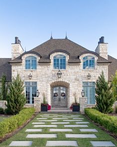 a large brick and stone house with two front doors