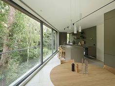 an open kitchen and dining room with large windows