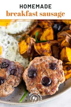 two breakfast sausage patties on a plate with eggs and potatoes