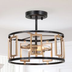 a black and gold chandelier hanging from a ceiling fixture with glass cubes