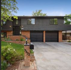 a large house with two garages in the front and one on the other side